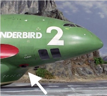 Close-up of the nose of Thunderbird 2 with an arrow highlighting roundels on its underside