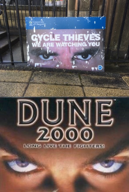 Juxtaposition of a University of Glasgow poster, 'Cycle Thieves - We Are Watching You', with a similar pair of eyes advertising the computer game 'Dune 2000 - Long Live The Fighters!'